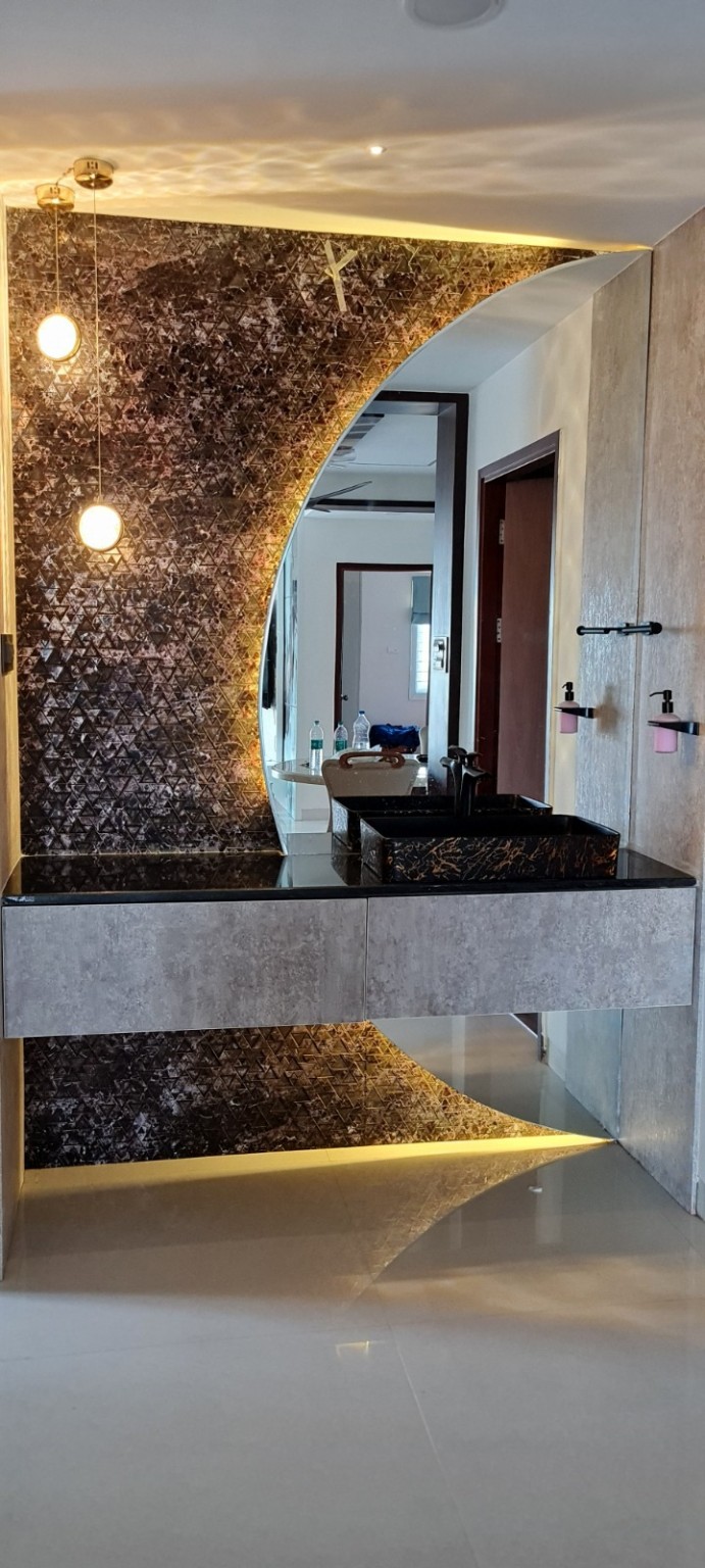 Completed washbasin vanity with circular mirror and feature lighting